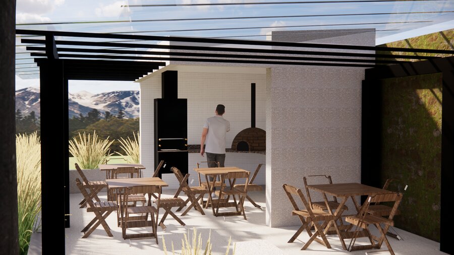 Área gourmet com churrasqueira, forno de pizza e vista para as montanhas